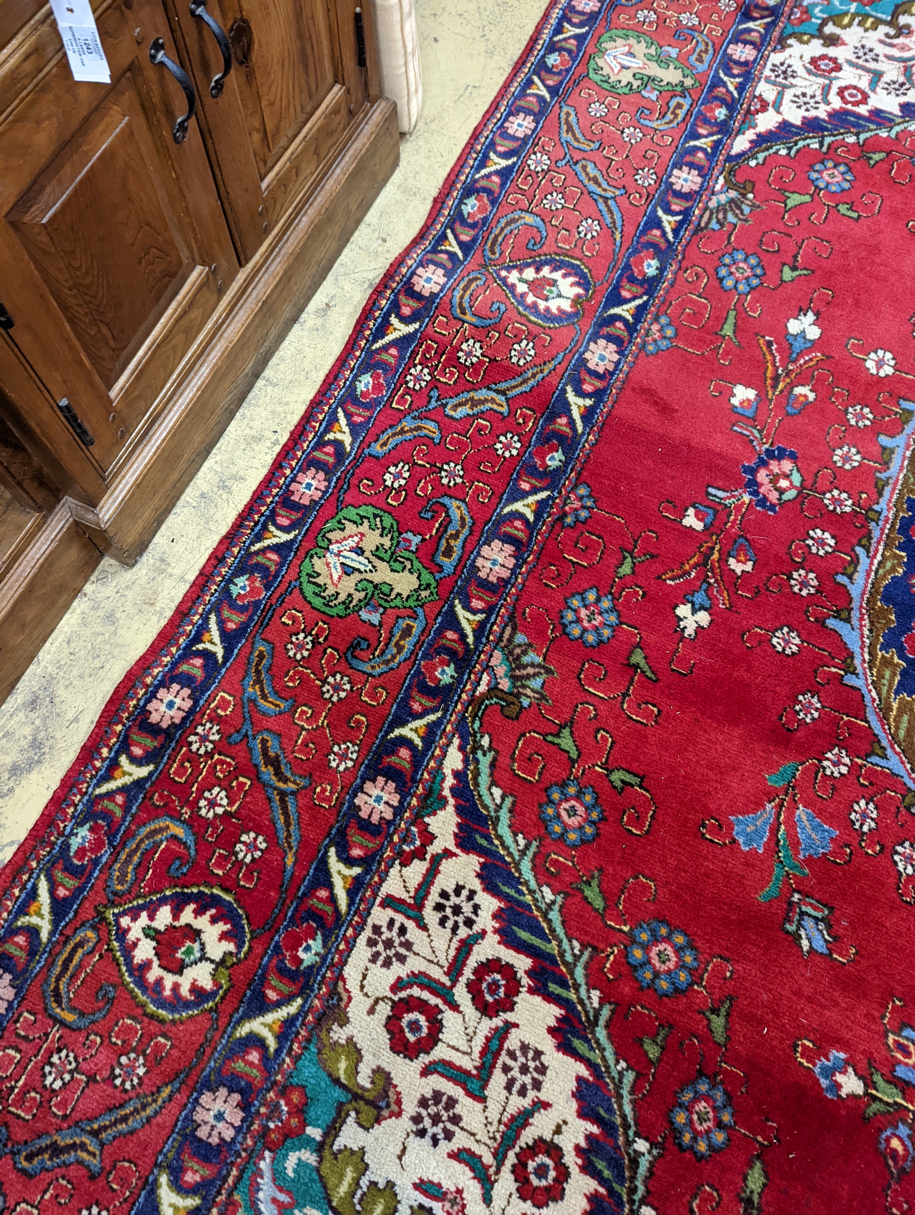 A Tabriz red ground carpet, 380 x 300cm